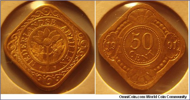 Netherlands Antilles | 
50 Cent, 1991 | 
24 mm, 5 gr. | 
Aureate Steel | 

Obverse: Orange blossom | 
Lettering: NEDERLANDSE ANTILLEN | 

Reverse: Denomination in centre divides date | 
Lettering: 50 CENT 1991 |