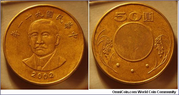 Taiwan | 
50 Dollars, 2002 (91) | 
28 mm, 10 gr. | 
Brass | 

Obverse: Chiang Kai-Shek, date above and below | 
Lettering: 年一十九國民華中 2002 | 

Reverse: Lantent image, denomination above | 
Lettering: 50圓 • • • |