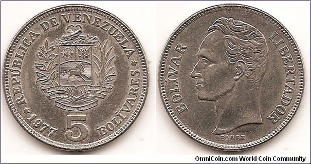 5 Bolivares
Y#53.1
15.0000 g., Nickel, 31 mm. Obv: National arms above ribbon, plants flank, cornucopias above, date and denomination below, six-pointed stars Rev: Head of Bolivar left Rev. Designer: Albert Barre Edge: Reeded