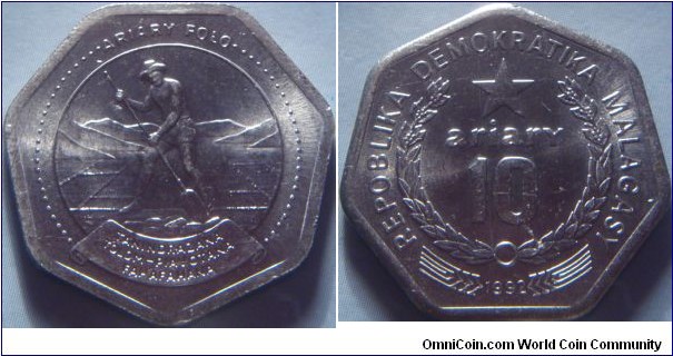 Madagascar | 
10 Ariary, 1992 | 
23.5 mm, 6.47 gr. | 
Stainless Steel | 

Obverse: Man cutting peat | 
Lettering: ARIARY FOLO TANINDRAZANA TOLOM-PIAVOTANA FAHAFAHANA | 

Reverse: Star within wreath | 
Lettering: REPOBLIKA DEMOKRATIKA MALAGASY * ariary 10 1992 |