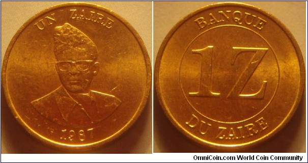 Zaïre | 
1 Zaïre, 1987 | 
21 mm, 5 gr. | 
Brass | 

Obverse: Mobutu Sese Seko, denomination above, dare below | 
Lettering: UN ZAIRE 1987 | 

Reverse: Denomination | 
Lettering: BANQUE DU ZAIRE 1Z |