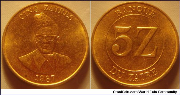 Zaïre | 
5 Zaïres, 1987 | 
24 mm, 6.9 gr. | 
Brass | 

Obverse: Mobutu Sese Seko, denomination above, dare below | 
Lettering: CINQ ZAIRES 1987 | 

Reverse: Denomination | 
Lettering: BANQUE DU ZAIRE 5Z |