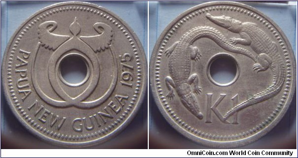 Papua New Guinea | 
1 Kina, 1975 | 
33.72 mm, 14.52 gr. | 
Copper-nickel | 

Obverse: Bank of Papua New Guinea logo, date right | 
Lettering: PAPUA NEW GUINEA 1975 | 

Reverse: Sea and River crocodiles, denomination below | 
Lettering: K1 |