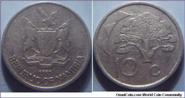 Namibia | 
10 Cent, 1993 | 
21.5 mm, 3.5 gr. | 
Nickel plated Steel | 

Obverse: National Coat of Arms, date below | 
Lettering: 1993 REPUBLIC OF NAMIBIA | 

Reverse: Camelthorn tree, partial sun design left, denomination below | 
Lettering: 10 c |