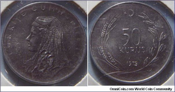 Turkey | 
50 Kuruş, 1973 | 
25 mm, 6.1 gr. |
Stainless Steel | 

Obverse: Anatolic bride's head facing left | 
Lettering: TÜRKİYE CUMHURİYETİ | 

Reverse: Denomination within wreath, star and crescent moon above, date below | 
Lettering: 50 KURUŞ 1973 |