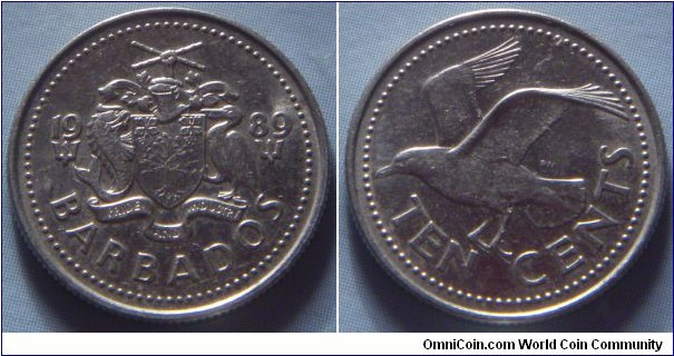 Barbados | 
10 Cents, 1989 | 
17.87 mm, 2.27 gr. | 
Copper-nickel | 

Obverse: National Coat of Arms divide date | 
Lettering: 1989 BARBADOS |

Reverse: Bird flying left, denomination below | 
Lettering: TEN CENTS |