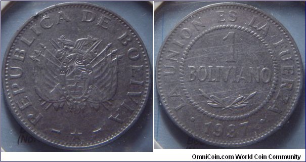 Bolivia | 
1 Boliviano, 1997 | 
27mm, 5 gr. | 
Stainless Steel | 

Obverse: National Coat of Arms | 
Lettering: - REPUBLICA DE BOLIVIA - * | 

Reverse: Denomination in centre, date below | 
Lettering: • LA UNION ES LA FUERZA • 1997 |