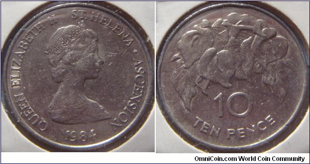 Saint Helena & Ascension | 
10 Pence, 1984 | 
28.5 mm, 11.31 gr. | 
Copper-nickel | 

Obverse: Queen Elizabeth II facing right | 
Lettering: QUEEN ELIZABETH II ST. HELENA ˖ ASCENSION 1984 | 

Reverse: Orchids, denomination below | 
Lettering: 10 TEN PENCE |