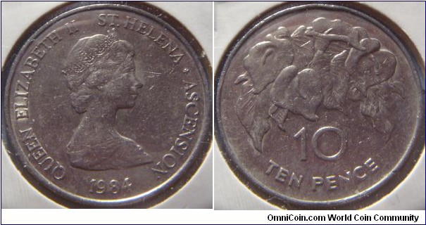 Saint Helena & Ascension | 
10 Pence, 1984 | 
28.5 mm, 11.31 gr. | 
Copper-nickel | 

Obverse: Queen Elizabeth II facing right | 
Lettering: QUEEN ELIZABETH II ST. HELENA ˖ ASCENSION 1984 | 

Reverse: Orchids, denomination below | 
Lettering: 10 TEN PENCE |