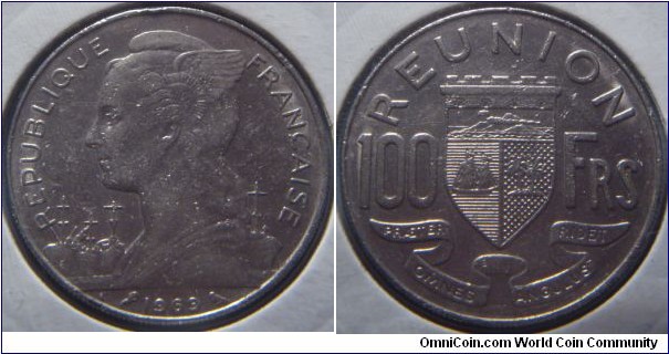 Réunion | 
100 Francs, 1969 | 
26.5 mm, 8.54 gr. | 
Nickel

Obverse: Winged liberty facing left, date below | 
Lettering: REPUBLIQUE FRANÇAISE 1969 | 

Reverse: National Coat of Arms divides denomination | 
Lettering: REUNION 100 FRS |