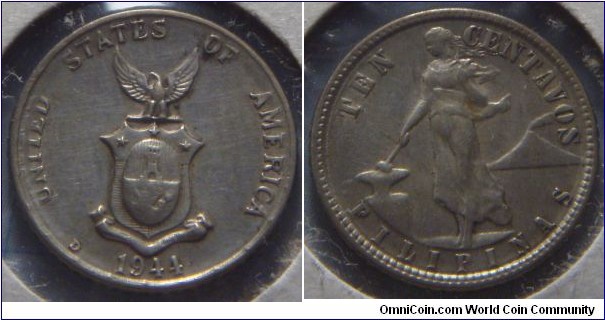 Philippines | 
10 Centavos, 1944 – U.S. Administration | 
16.7 mm, 2 gr. | 
Silver (.750) | 

Obverse: Coat of Arms, date below | 
Lettering: UNITED STATES OF AMERICA 1944 | 

Reverse: Lady wearing flowing dress, holding a hammer resting on anvil, active volcano (Mt. Mayon) on right | 
Lettering: TEN CENTAVOS FILIPINAS |