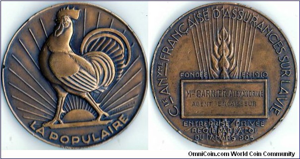 Bronze medallion issued by La Populaire, a French assurance company. This example appears to be a service award. 