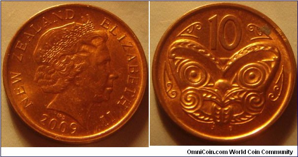 New Zealand |
10 Cents, 2009 |
20.5 mm, 3.3 gr. |
Copper plated Steel |

Obverse: Queen Elizabeth II facing right, date below |
Lettering: NEW ZEALAND ELIZABETH II 2009 |

Reverse: Maori Mask, denomination above |
Lettering: 10 |