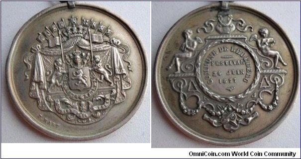 1877 Belgium Commune De Ledeberg Music Festival Medal by P. Hart. Silver: 46.2MM./27 gm.
Obv: Belgium Coat of Arms signed P. Hart. Rev: Angels or Cherub playing music and reading with legend COMMUNE DE LEDEBERG/FESTIVAL 24 JUIN 1877.
