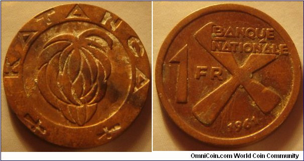 Katanga |
1 Franc, 1961 |
22 mm, 5 gr. |
Bronze |

Obverse: Bunch of bananas |
Lettering: KATANGA |

Reverse: Denomination left, date below. The cross symbolizes iron bars |
Lettering: BANQUE NATIONALE 1 FR 1961 |