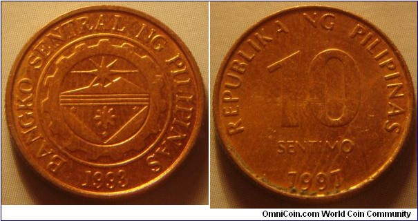 Philippines | 
10 Sentimo, 1997 | 
16.7 mm, 2 gr. | 
Copper plated Steel | 

Obverse: Bank seal with legend around and year of the establishment on the Central Bank below | 
Lettering: BANGKO SENTRAL NG PILIPINAS 1993 | 

Reverse: Denomination, date below | 
Lettering: REPUBLIKA NG PILIPINAS 10 SENTIMO 1997 |