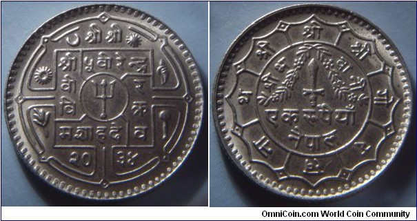 Nepal | 
1 Rupee, 1977 (2034) | 
27 mm, 7.5 gr. | 
Copper-nickel | 

Obverse: Small trident within circle at centre, date below | 
Lettering: श्री श्री श्री ५ वीहेन्द्र वी र वि क्र मशाहदे व २०३४ | 

Reverse: Garland on dagger, denomination below | 
Lettering: श्री श्री श्री गोरखनाथ श्री भवानी एक रुपैयाँ नेपाल |