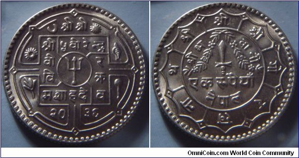 Nepal | 
1 Rupee, 1979 (2036) | 
27 mm, 7.5 gr. | 
Copper-nickel | 

Obverse: Small trident within circle at centre, date below | 
Lettering: श्री श्री श्री ५ वीहेन्द्र वी र वि क्र मशाहदे व २०३६ | 

Reverse: Garland on dagger, denomination below | 
Lettering: श्री श्री श्री गोरखनाथ श्री भवानी एक रुपैयाँ नेपाल |