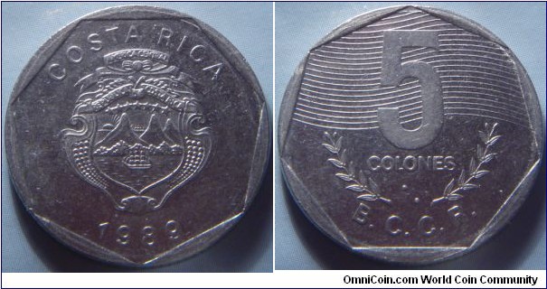 Costa Rica | 
5 Colones, 1989 | 
25 mm, 7.25 gr. |  
Stainless Steel | 

Obverse: National Coat of Arms, date below | 
Lettering: COSTA RICA 1989 | 

Reverse: Denomination in numbers and Braille above coffee branches| 
Lettering: 5 COLONES ⠑ B.C.C.R. |