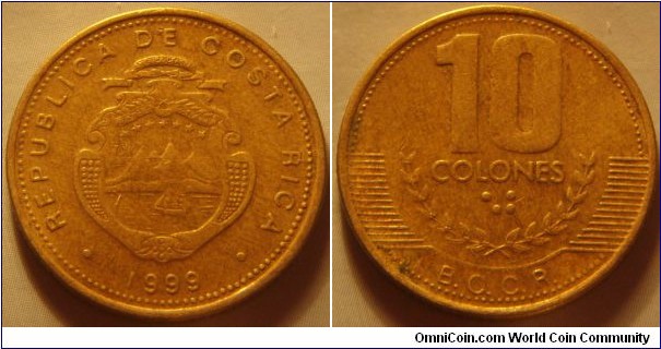 Costa Rica | 
10 Colones, 1999 | 
24 mm, 5 gr. |  
Brass | 

Obverse: National Coat of Arms, date below | 
Lettering: • REPUBLICA COSTA RICA • 1989 | 

Reverse: Denomination in numbers and Braille above coffee branches| 
Lettering: 10 COLONES ⠈⠚ B.C.C.R. |