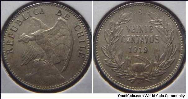 Chile | 
20 Centavos, 1919 | 
21 mm, 3 gr. | 
Silver (.400) | 

Obverse: Andean Condor on rock facing left | 
Lettering: REPUBLICA DE CHILE | 

Reverse: Denomination within wreath, date below | 
Lettering: VEINTE CENTAVOS 1919 |