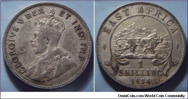 East Africa | 
1 Shilling, 1924 | 
27.8 mm, 7.78 gr. | 
Silver (.250) | 

Obverse: King George V facing left | 
Lettering: GEORGIVS V REX ER IND:IMP: | 

Reverse: A lion facing right, mountain in background, denomination below, date bottom | 
Lettering: ¬– EAST AFRICA – 1 SHILLING 1924 |