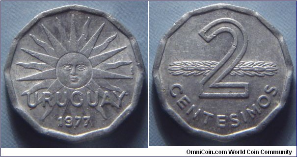 Uruguay | 
2 Centésimos, 1977 | 
21 mm, 1.6 gr. | 
Aluminium | 

Obverse: Sun with face, date below | 
Lettering: URUGUAY 1977 | 

Reverse: Denomination in front of supine stalk | 
Lettering: 2 CENTESIMOS |