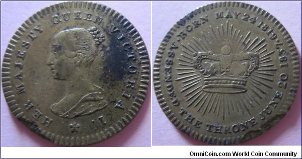 small brass token celebrating the crowning of Victoria