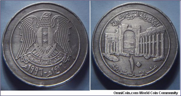 Syria | 
10 Pounds, 1996 | 
26.4 mm, 7 gr. | 
Copper-nickel | 

Obverse: National Coat of Arms, date below | 
Lettering: م١٩٩٦ - ھ١٤١٦ |  

Reverse: the ancient city of Palmyra, denomination below | 
Lettering: الجمهورية العربية السورية ١٠ عشر ليرات سورية |