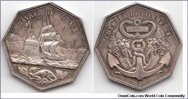 1900 o.j. France Harve de Grace Chambre de Commerce Octagon Jeton by Barre. Silver 34MM./16.23 gm.
Obv:  Legend HAVRE DE GRACE. A sailing ship with harbour view. Coats of Arm of Havre on bottom. Signed Barre. Rev: Legend CHAMBRE DE COMMERCE. Huge Anchor with 2 snakes surround. Horn of Planty on both side.
