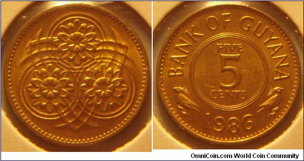 Guyana | 
5 Cents, 1986 | 
19.5 mm, 2.5 gr. | 
Nickel-brass | 

Obverse: Stylized Lotus Flower | 

Reverse: Denomination, date below| 
Lettering: BANK OF GUYANA FIVE 5 CENTS 1986 |