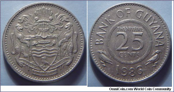 Guyana | 
25 Cents, 1986 | 
21.85 mm, 4.25 gr. | 
Copper-nickel | 

Obverse: National Coat of Arms | 

Reverse: Denomination, date below | 
Lettering: BANK OF GUYANA TWENTYFIVE 25 CENTS 1986 |
