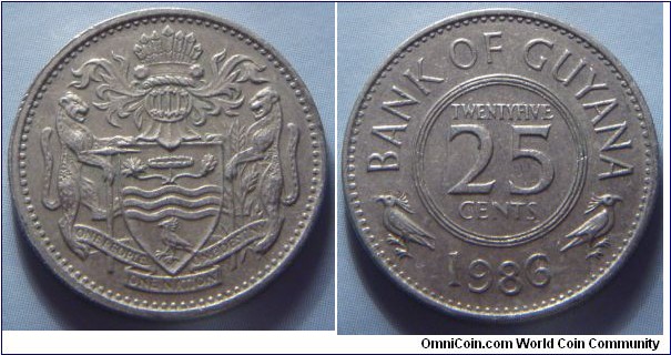 Guyana | 
25 Cents, 1986 | 
21.85 mm, 4.25 gr. | 
Copper-nickel | 

Obverse: National Coat of Arms | 

Reverse: Denomination, date below | 
Lettering: BANK OF GUYANA TWENTYFIVE 25 CENTS 1986 |