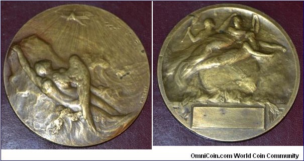 1900 o.j. Belgium Icarus Aviation unidentified Medal by Edouard-Pierre Blin (1877-1946). Bronze: 65MM.
Obv: Relief of Icarus holding on to a rock in a sea with a biplane flying above. Rev: Relief of three female figures with blank inscription block.
