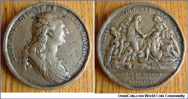 1785 France Louis XVI The Channel of the Saone in Yonne Medal. Plated Gilted Bronze: 52MM
Obv: Draped & Cuirassed bust of Louis XVI to right. Legend LOUIS XVI ROI FRANCE ET DE NAVARRE. Signed S.DU VIVIER. Rev:  Classical figures representing the Rhone, saone, Seine & Yonne. Legend NOUVELLE JONCTION DES DEUX MERS. 2 rivers, the Rhone & the Saone meet both Seine and Yonne rivers, signed DU VIVIAN. Exergue CANEL SAONE A YONNE MDCCLXXXV.
