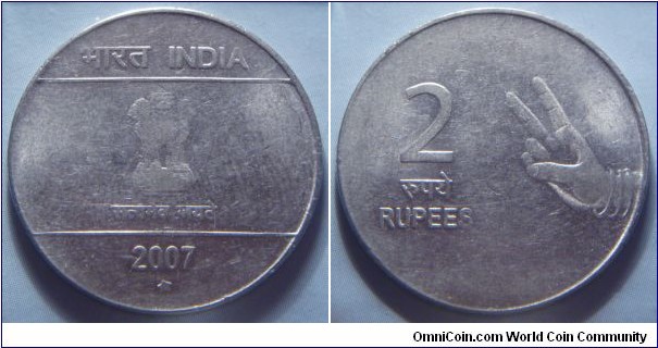 India | 
2 Rupees, 2007 | 
27 mm, 5.8 gr. | 
Stainless Steel | 

Obverse: Ashoka Lion Capitol, date below | 
Lettering: भारत INDIA रूपये सत्यमेव जयते 2007 | 

Reverse: A right hand making the peace sign, denomination left| 
Lettering: 2 रूपये RUPEES |