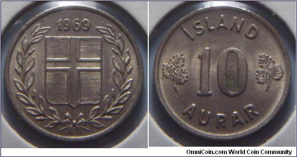 Iceland | 
10 Aurar, 1969 | 
15 mm, 1.6 gr. | 
Copper-nickel | 

Obverse: Flag of Iceland in shield within laurel wreath, date above |
Lettering: 1969 | 

Reverse: Denomination | 
Lettering: ÍSLAND 10 AURAR |