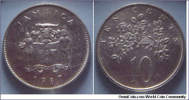 Jamaica | 
10 Cents, 1987 – non-magnetic | 
23.6 mm, 5.75 gr. | 
Copper-nickel | 

Obverse: National Coat of Arms, date below | 
Lettering: JAMAICA 1987 | 

Reverse: Butterfly on flower, denomination above | 
Lettering: TEN CENTS 10 |