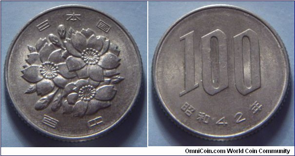 Japan | 
100 Yen, 1967 | 
22.5 mm, 4.2 gr. | 
Copper-nickel | 

Obverse: Cherry blossoms, denomination below | 
Lettering: 日本国 百円 | 

Reverse: Denomination, date below | 
Lettering: 100 昭和42年 |