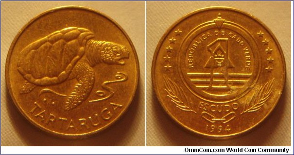 Cape Verde | 
1 Escudo, 1994 | 
18 mm, 2.5 gr. | 
Brass plated Steel | 

Obverse: Loggerbead Sea Turtle | 
Lettering: TARTARUGA | 

Reverse: Denomination on National Coat of Arms, date below | 
Lettering: REPÚBLICA DE CABO VERDE 1 ESCUDO 1994 |
