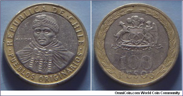 Chile | 
100 Pesos, 2008 | 
23.5 mm, 7.58 gr. | 
Bi-Metallic: Copper-nickel centre in Aluminium-bronze ring | 

Obverse: Mapuche Indian woman | 
Lettering: • REPUBLICA DE CHILE • PUEBLOS ORIGINARIOS |  

Reverse: National Coat of Arms within wreath, date below, denomination bottom | 
Lettering: 2008 100 PESOS |
