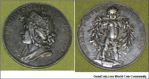 1800 o j Czech Republic Commercial and Industrial Chamber in Prague Medal. Silver: 56MM./67 gms.
Obv: Czech female with hat & wreath to right. Legend OBCHODNI A ZIVNOSTENSKA KOMORA V PRAZE. Rev: Nude Gemini surround by huge wreather & standing on industrial tools. Legend HANDELS-U-GEWERBE KAMMER IN PRAG & a star. 
