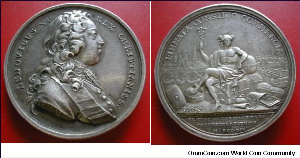 1719 France Louis XV Creation de La Chambre de Commerce de Rouen Medal by DU VIVIER. Silver: 41MM./41gms.
Obv: Bust of Louis XV to right. Legend LUD.XV.REX CHRISTIANISS.. Rev: Mercury seated on cargo alone pier holding caducus on right hand, Acient ships back ground. Legend FIRMATA CONSILIO COMMERCIA. Exergue  IN VIRI ROTHOMAGENESES COMMERCIIS REGUNDIS M.DCC.XIX
