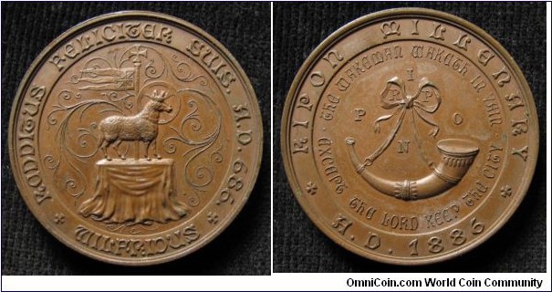 686-1886 UK Ripon Millenary Borough of Harrogate, North Yorkshire Medal. Bronze: 36MM.
Obv: Wolf standing on table with ancient flag backgroung. Legend RADDIEUS RELICIGAR SUIS H.D.688 WILFRIDUS. Obv: Horn with Love-knock Ribbon. Legend THE WAKEMAR WAKGER IN VAIR. OXAEPE THE LORD KEEP THE CITY. RIPON MILLENARY.H.D. 1886.
