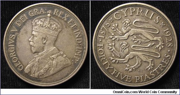 1928 Cyprus 50th Anniversary British Rule King George V(1910-1936) 45 Piastres. Silver: 40MM.
Obv: Draped & Crowned bust of George V to lrft. Legend GEORGIVS V DEI GRA: REX ET IND: IMP:. Rev: Two rampant Lions represented symbol of Britian. Legend CYPRUS 1878-1928. FORTY FIVE PIASTRES. Signed K.G.
