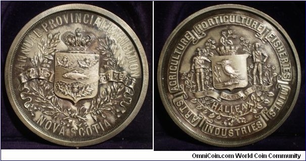 1904 Canada Provincial Exhibition Nova Scotia Halifax Sterling Industry Merit Medal. Silver: 57MM.
Obv: Coat of Arms of Nova Scotia with Crown above, Wreath surround & banner AWARED FOR MERIT. Legend ANNUAL PROVINCIAL EXHIBITION. Rev: Halifax Shield with banner E MARI MERCES surround by wreath HALIFAX.. Legend ARTS AGRICULTURE HORTICULTURE FISHERIES MINES INDUSTRIES. (The Exhibition is now held in Truro. The Agricultural Fair-Grounds where the exhibition was held were leveled in 1919 & rebuilt 4 years later.)
