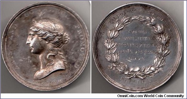 1837 UK Isis Socirty of Arts Medal by T. WYON JVN SC. Silver: 40.25MM.40.14gms.
Obv: Diademed bust of Isis Left, Legend ARTS ANS COMMERCE PROMOTED. Signed T.WYON JVN SC. Rev: Laurel wreath with engraved details TO W TALBOT AGAR Esq. MDCCCXXXVII and within FOR HIS INSTRUMENT FOR TRUNING OVER THE LEAVES OF A MUSIC BOOK.
