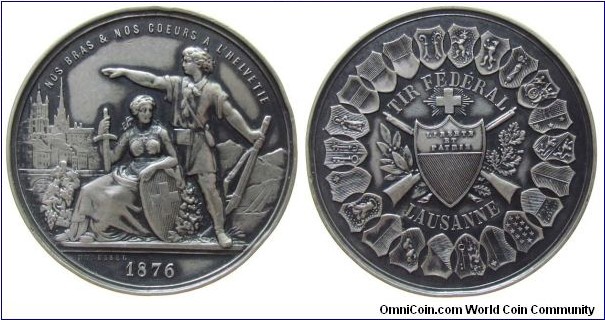 1876 Swiss Lausanne (Waad/Vaud) eidgenossische Schutzenfest Medal by Durussel. Silver plated Bronze: 45.8MM./45.86 gms.
Obv: Male figure with gun next to Helvetia with crest & sword. Rev: Coat of Arms Lausanne crossed in front of guns, surrounded the 22 cantonal coat of arms of Swiss.
