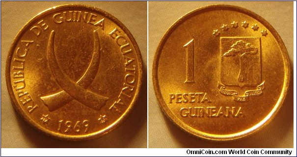 Equatorial Guinea | 
1 Peseta, 1969 | 
19.5 mm, 3.42 gr. | 
Aluminium-bronze | 

Obverse: Crossed tusks, date below | 
Lettering: * REPÚBLICA DE GUINEA ECUATORIAL * 1969 | 

Reverse: National Coat of Arms, denomination left | 
Lettering: 1 PESETA GUINEANA | 