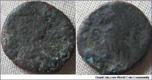 almost Unidentifiable roman coin, however small amount of detail on the reverse puts this at around the time of Antonia as well as the slight reminants of the head shape, reverse S-C, Claudius, togate, standing left, holding simpulum
